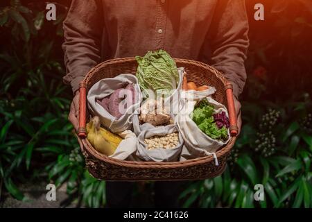 eco friendly and reusable zero waste cotton bags in basket Stock Photo