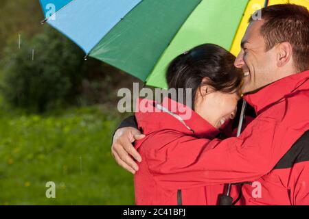 couple enjoying a walk in the rain in England Stock Photo