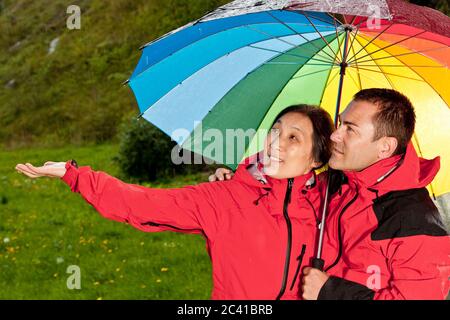 couple enjoying a walk in the rain in England Stock Photo