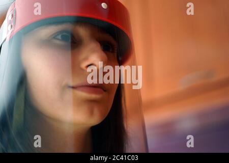 Female Doctor wearing face shield and PPE suit for Coronavirus outbreak. Stock Photo