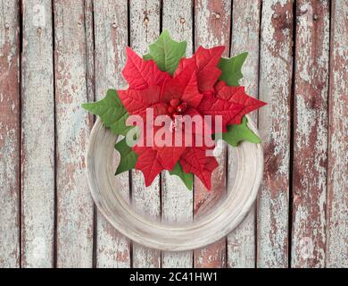 Poinsettia on the old background. Handmade flower fabric foam-iran. Artificial flowers made from sponge rubber. Stock Photo