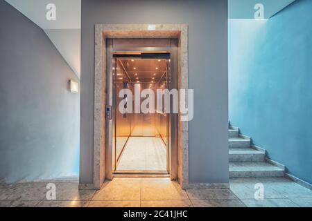 Elevator and stairs up and down in a modern elegant building Stock Photo