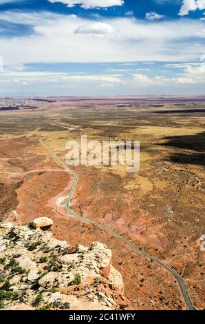 Aerial shot road leading through beautiful colourful desert Stock Photo