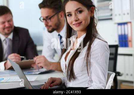 Beautiful young woman using laptop in modern office Stock Photo
