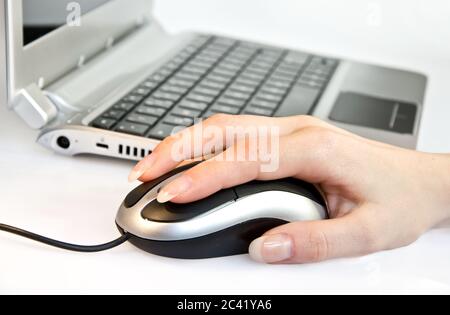 Female hand using computer mouse Stock Photo