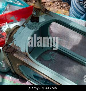 Someone painting a wooden lantern pastel green Stock Photo
