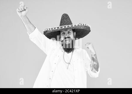 Mexican performer. Mexican traditions. Explore mexican culture. Celebrate traditional holiday. Happy man sombrero souvenir straw hat. Plan summer vacation. Festival concept. Hipster having fun. Stock Photo