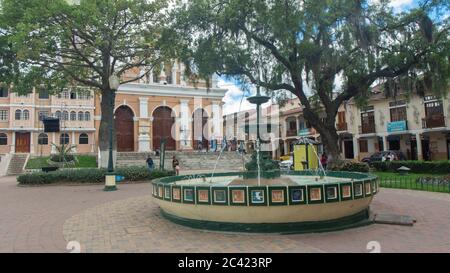 Inmaculada Concepcion de Loja, Loja / Ecuador - March 30 2019: Water fountain in Independence Square with church of San Sebastian in the background Stock Photo