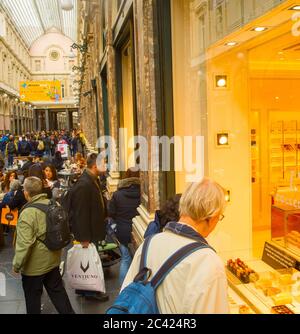 BRUSSELS, BELGIUM - OCTOBER 5, 2019: People choosing chocolate candy at St. Hubert Galleries. The Saint-Hubert Royal Galleries are shopping arcades in Stock Photo
