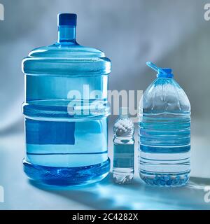 Clean drinking bottled water in bottles of various sizes. Stock Photo