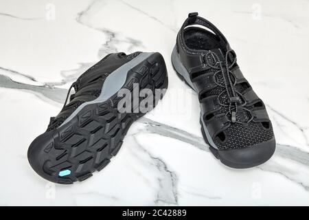 Quick-drying water shoes for men, black boots made of polyester and polyurethane on the sole of artificial rubber. Sandals for boating with quick laci Stock Photo