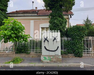 Simple smiley face graffiti art on electricity box in the street, Cluj-Napoca, Romania Stock Photo