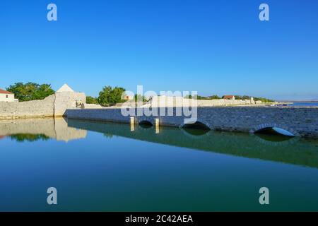 Bridge and old defensive walls of medieval town Nin in Dalmatia, Croatia Stock Photo