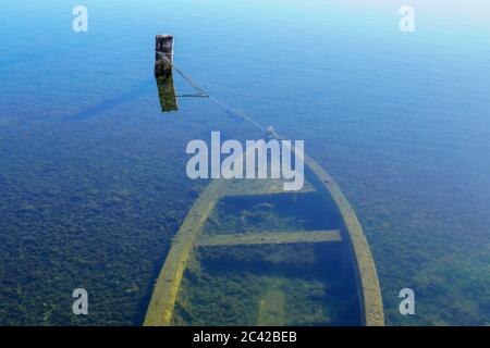Sunken fishing boat abandoned in the sea Stock Photo