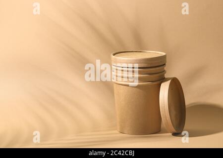 Craft paper soup cup on brown background. Empty container for take away food. Ecological individual package. Zero Waste. Stock Photo