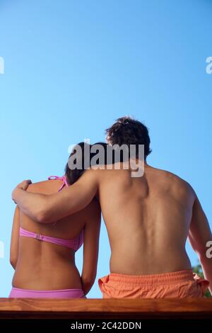 Young couple sitting side by side, rear view Stock Photo