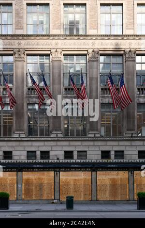 New York City, New York - June 11, 2020: Saks Fifth Avenue closed during the COVID-19 pandemic, with boarded up windows to protect against looting as Stock Photo