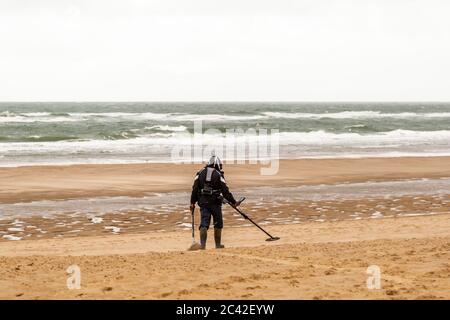 Beach walker with metal detector at Veere-Oostkapelle, The Netherlands Stock Photo