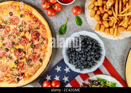 Memorial Day party table with delicious food and flag for american holiday. Stock Photo