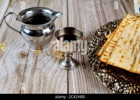 Matzah and a silver cup full of wine. Jewish holidays Passover concept. Stock Photo