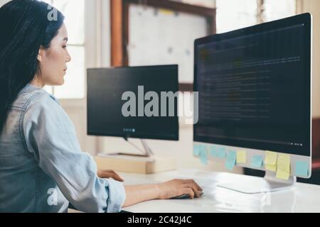 Programmer is coding and programming software. Software developer typing data code, working on project. Stock Photo