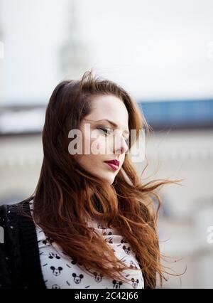 Portrait of beautiful young woman standing outdoors on the wind Stock Photo