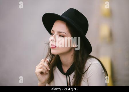 Portrait of young woman  wearing black hat Stock Photo