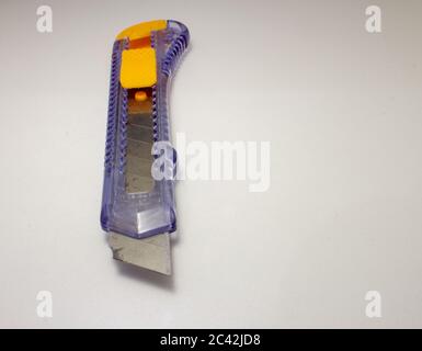 Plastic utility knife with old and rusted blade Stock Photo