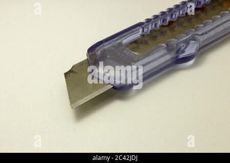 Plastic utility knife with old and rusted blade Stock Photo