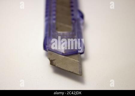 Plastic utility knife with old and rusted blade Stock Photo