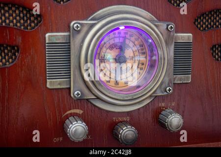 An old fashion radio, featuring a gauge showing the current frequency and knobs to control the system Stock Photo