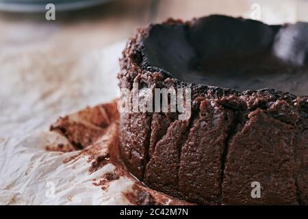 Close up of a chocolate basque burnt cheesecake on a wooden table Stock Photo