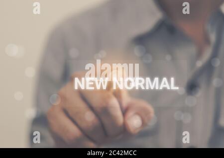businessman hand touching new normal on virtual screens. business concept Stock Photo