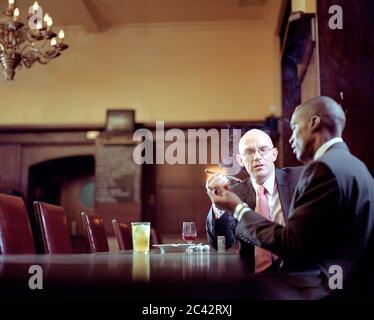 Businessmen smoke cigar - bar Stock Photo