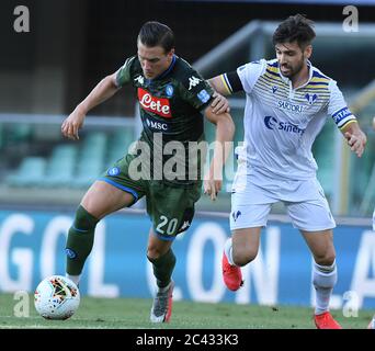 Napoli, Italy. 23rd June, 2020. Napoli's Piotr Zielinski (L) vies with Verona's Miguel Veloso during a Serie A football match in Verona, Italy, June 23, 2020. Credit: Alberto Lingria/Xinhua/Alamy Live News Stock Photo