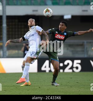 Napoli, Italy. 23rd June, 2020. Napoli's Allan (R) vies with Verona's Mattia Zaccagni during a Serie A football match in Verona, Italy, June 23, 2020. Credit: Alberto Lingria/Xinhua/Alamy Live News Stock Photo