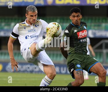 Napoli, Italy. 23rd June, 2020. Napoli's Allan (R) vies with Verona's Valerio Verre during a Serie A football match in Verona, Italy, June 23, 2020. Credit: Alberto Lingria/Xinhua/Alamy Live News Stock Photo