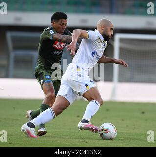 Napoli, Italy. 23rd June, 2020. Napoli's Allan (L) vies with Verona's Sofyan Amrabat during a Serie A football match in Verona, Italy, June 23, 2020. Credit: Alberto Lingria/Xinhua/Alamy Live News Stock Photo