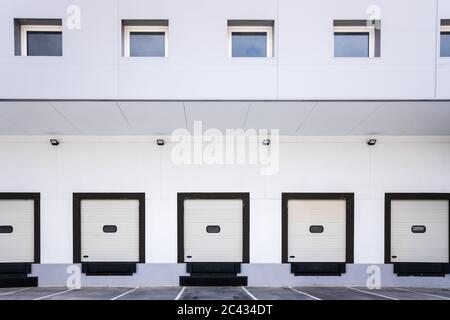 Closed doors of truck loading docks in a factory without activity. Stock Photo