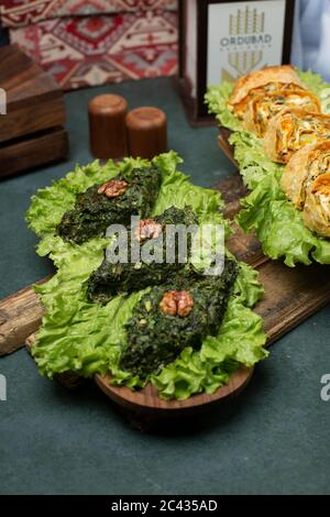 Green herbal omlette on a lettuce leaf on a wooden board Stock Photo