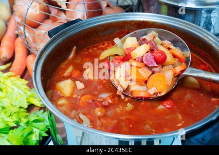 Vegetable and ham hock soup in a pot. Stock Photo