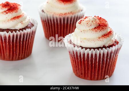 Three Red Velvet Cupcakes on Marble Stock Photo