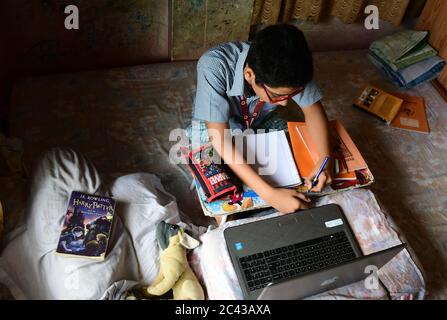 Online learning during Coronavirus outbreak. A school student attending online class. Due to COVID19 outbreak and lockdown all educations decided to r Stock Photo