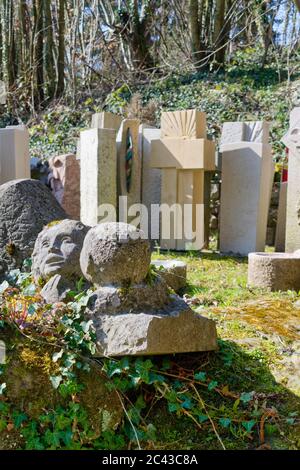 A traditional carved stone memorial marker painted with blue ...
