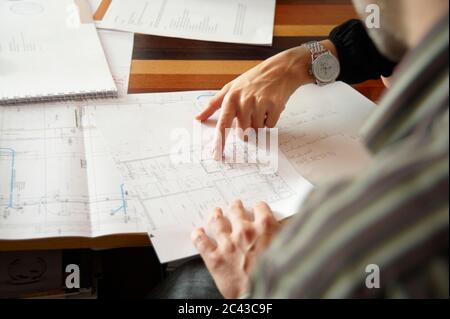 Hand of a woman points to blueprint Stock Photo