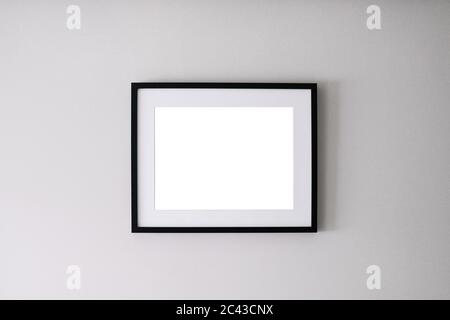 Blank frame on a white wall background Stock Photo