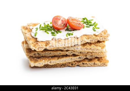 Crispbread with creamy cheese, chive and cherry tomatoes isolated on white background. Stock Photo