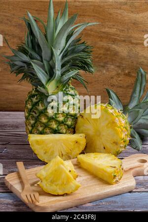 Fresh sliced pineapple on wooden board. Stock Photo