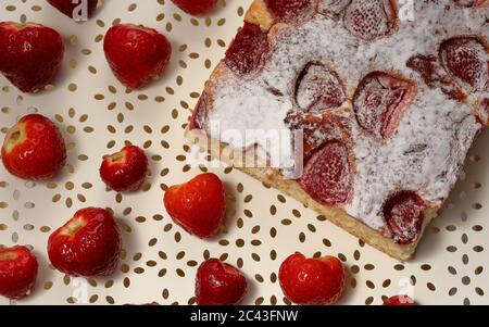 Stawberry cake with fresh strawberries around close up top view, seasonal summer home made dessert. Stock Photo