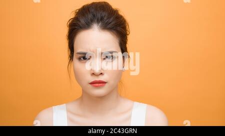 Asian woman with bored expression is waiting for some one or thinking of something Stock Photo